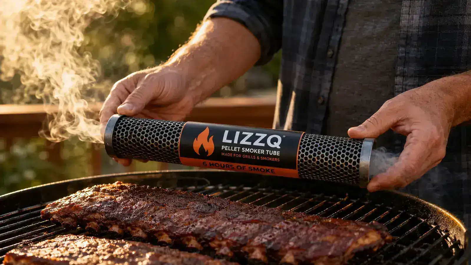 Close-up of a perforated stainless steel smoker tube with hickory wood pellets visible inside